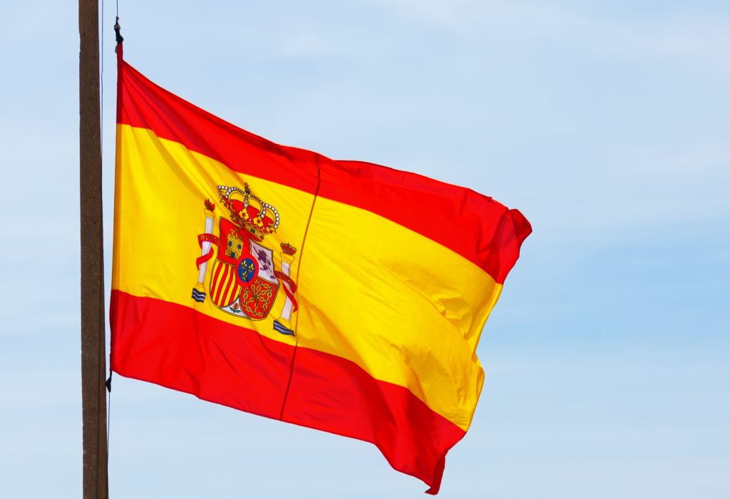 Flying Spain flag over sky background